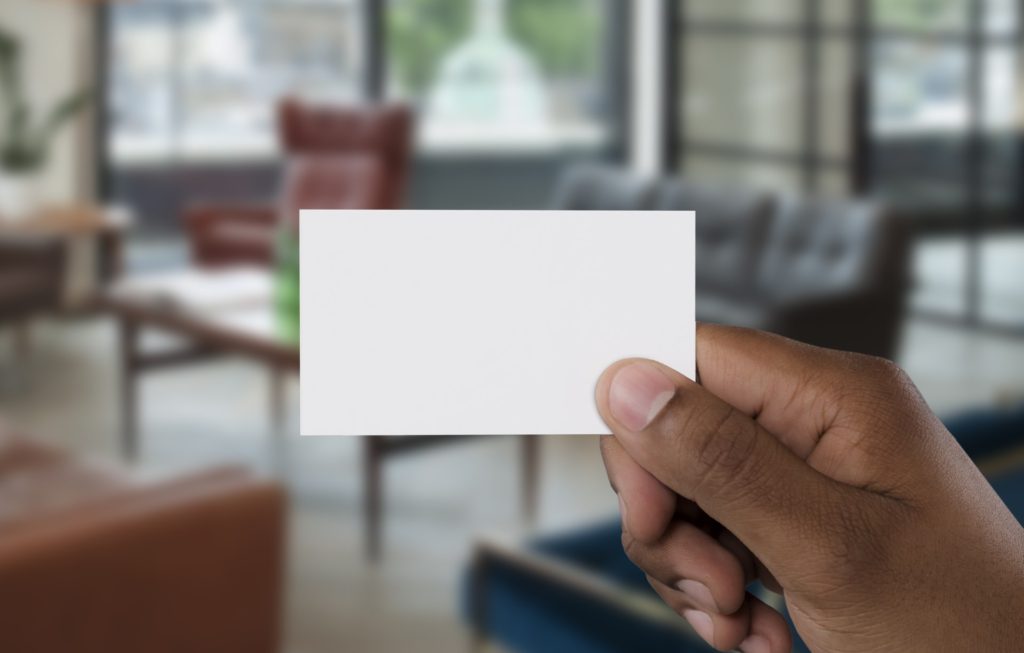 Person holding empty business card